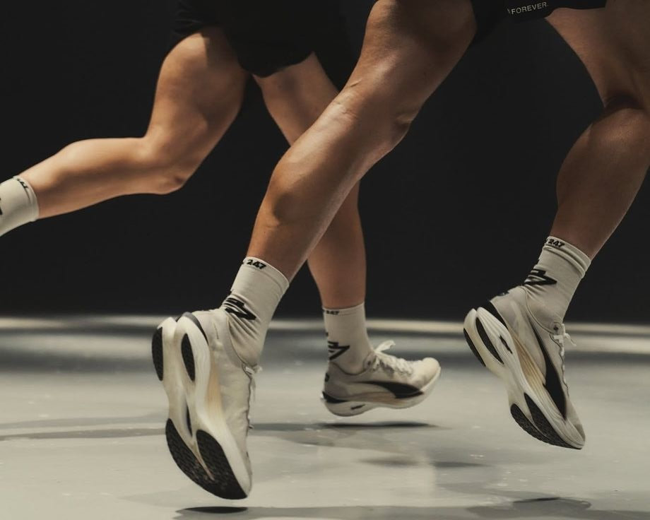 Two runners' legs and trainers mid-stride